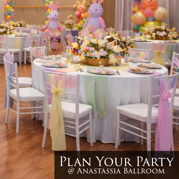 pastel theme easter with bowtie chair wraps, white linens, colorful plates, floral centerpiece baskets, bunny statues
