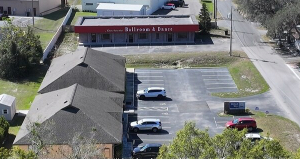 overview aerial showing leesburg florida dance studio with red roof and white letters
