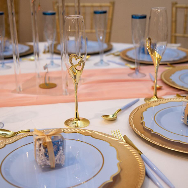 gold table chargers with blue plates and handcrafted keepsakes