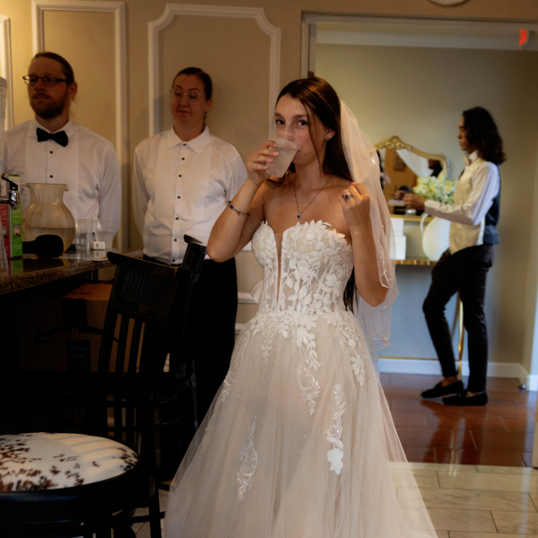 bride drinking water in the modern bar area
