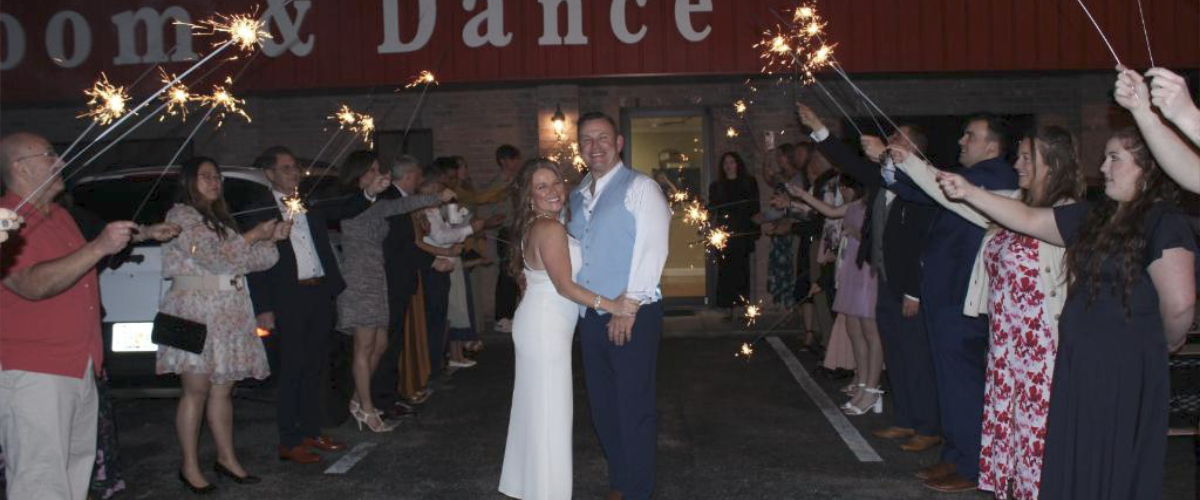 wedding party sparkling sendoff to limousine
